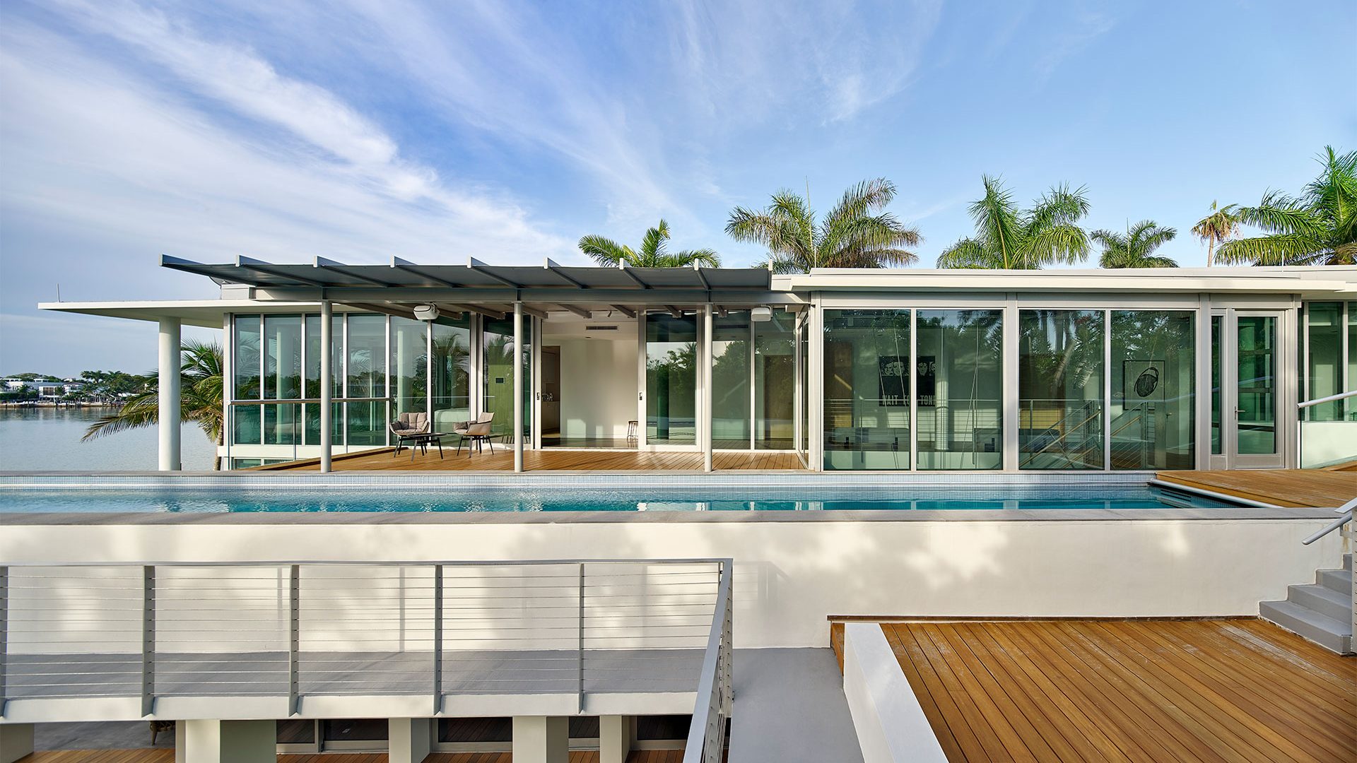 Outdoor deck overlooking the water in Florida by Woolems Luxury Builders