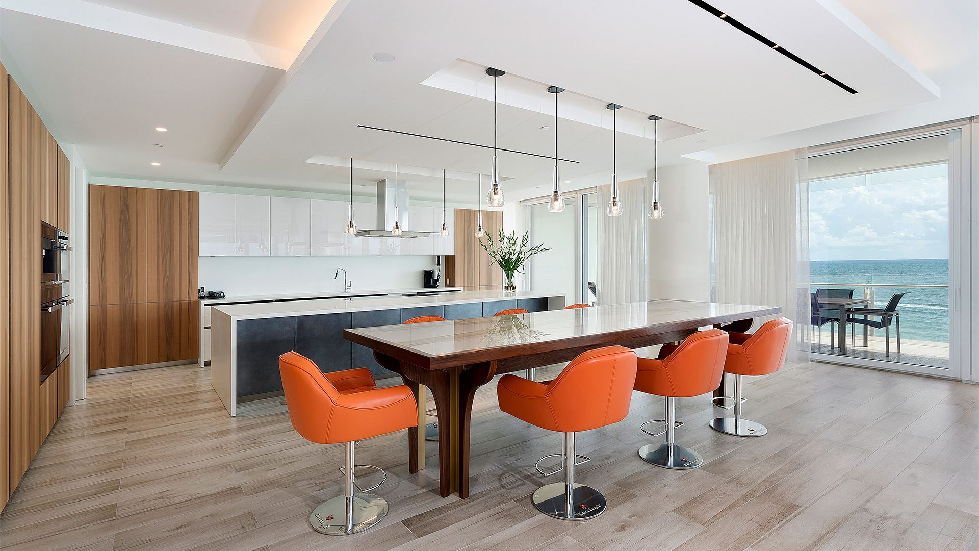 Luxury Open floor plan kitchen & dining room overlooking the ocean in Florida by Woolems Luxury Builders